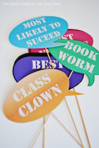 Decorations for a graduation party. Signs that say class clown, book worm, and more.